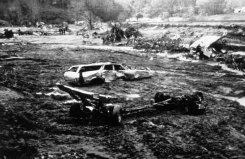 Twisted remains of a vehicle and other debris following a flash flood